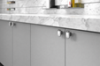 Richelieu 7345 cabinet knob set of 2 installed on grey cabinetry in chrome finish