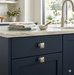 Richelieu 7653 brushed nickel cabinet knob installed on blue cabinet drawer