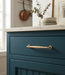 Richelieu 790 traditional metal pull in satin brass installed on a blue vanity drawer