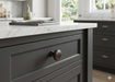 Richelieu 7903 cabinet knob installed on cabinetry in dark bronze finish