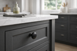 Richelieu 7903 cabinet knob installed on dark cabinetry in matte black finish