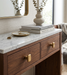 Richelieu 8655 brushed aurum gold cabinet knobs installed on wood vanity drawers