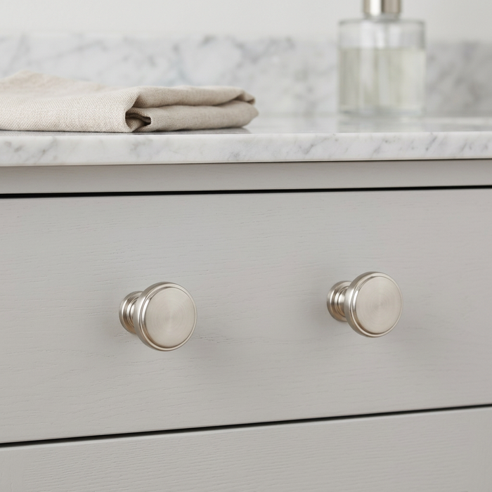 Richelieu 8726 brushed nickel cabinet knob set of 2 installed on grey drawer