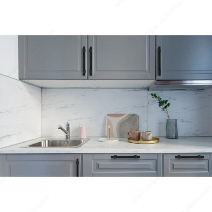 Richelieu 8747 modern metal pull in matte black  installed in a modern kitchen
