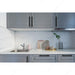 Richelieu 8747 modern metal pull in matte black  installed in a modern kitchen