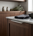 Richelieu 9898 stainless steel edge pull installed on modern kitchen cabinetry