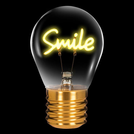 Smile neon LED light bulb with warm white filament glowing on black background