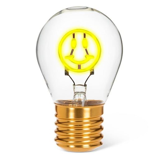 Smiley face neon LED light bulb with yellow glowing filament in clear glass on white background
