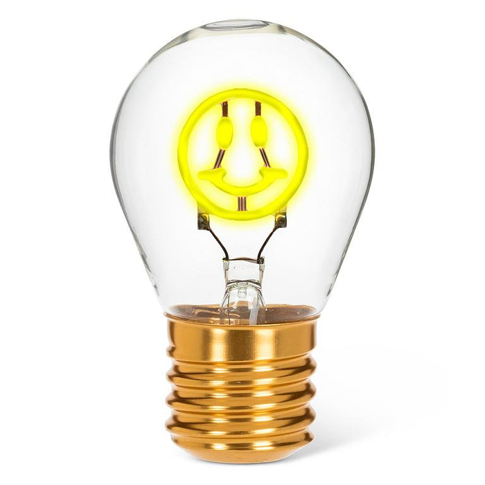 Smiley face neon LED light bulb with yellow glowing filament in clear glass on white background
