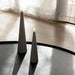 Uyuni sandstone flameless cone candle on a modern black table with soft ambient lighting