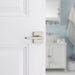 Weiser Halifax square privacy lever installed on white bathroom door
