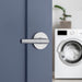 Weiser Milan round passage door lever installed on interior laundry room door