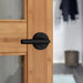 Weiser Milan round dummy door lever matte black installed on interior door