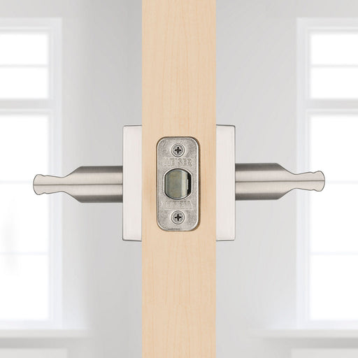 Side view of Weiser Montreal door handle installed on a light wood interior door.