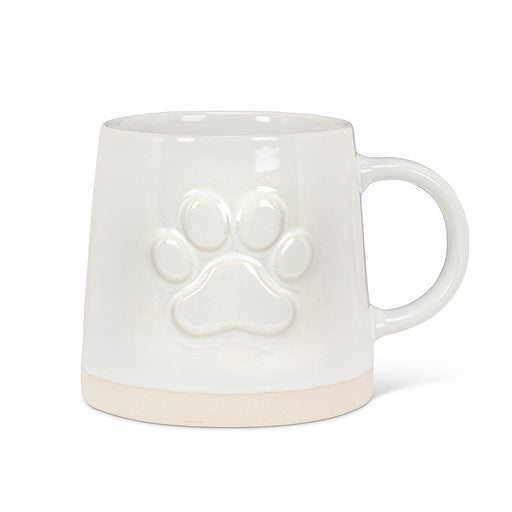 White stoneware mug with raised paw print design and wide natural-toned base